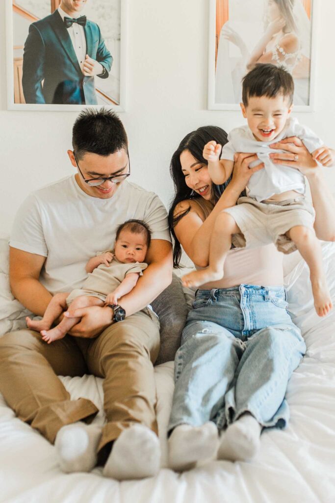 Lifestyle in-home newborn session Vancouver WA with parent and baby snuggling in a cozy bedroom