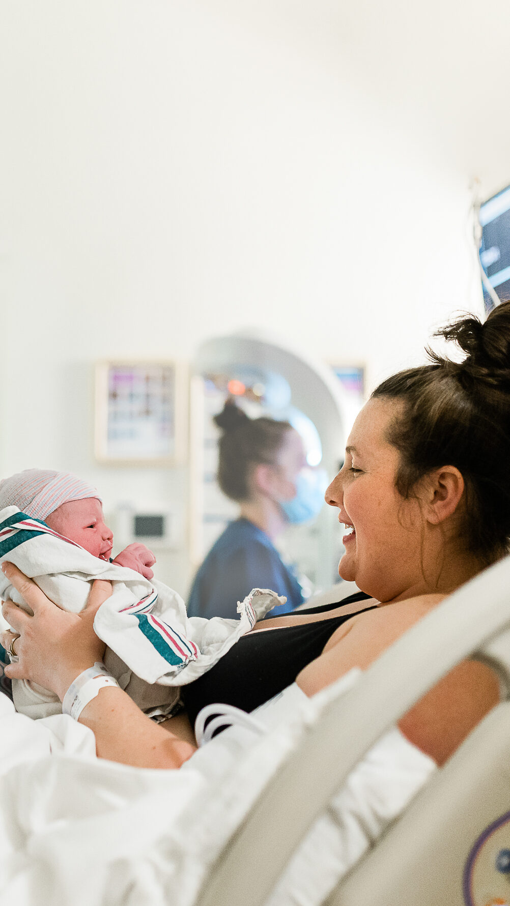 Mother recommenidng pelvic floor therapy during pregnancy and meeting her newborn baby boy in a birthing center.