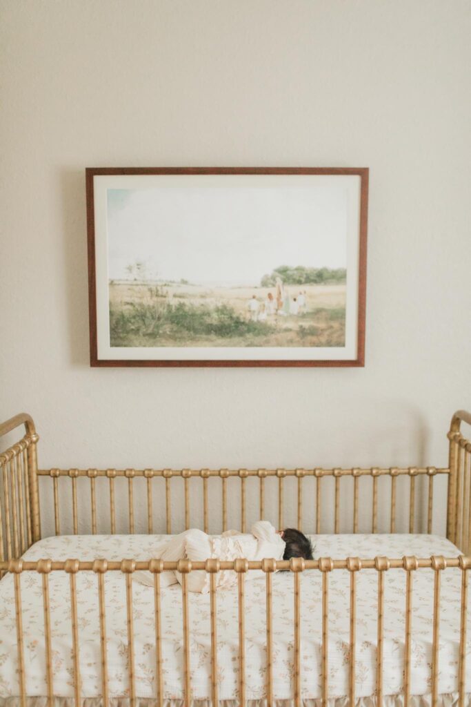 No-face newborn photo of baby resting in crib facing away from camera, captured by a Portland OR in-home newborn photographer