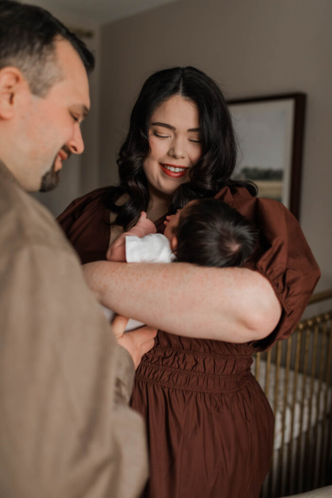 No-face newborn photo of baby snuggled into parent’s chest, taken by a Portland OR newborn photographer using natural light