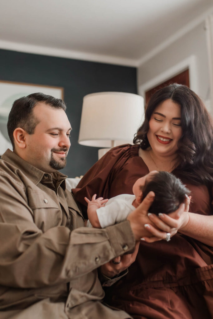 Over-the-shoulder newborn photo with baby facing away, photographed by a natural light newborn photographer in Portland OR