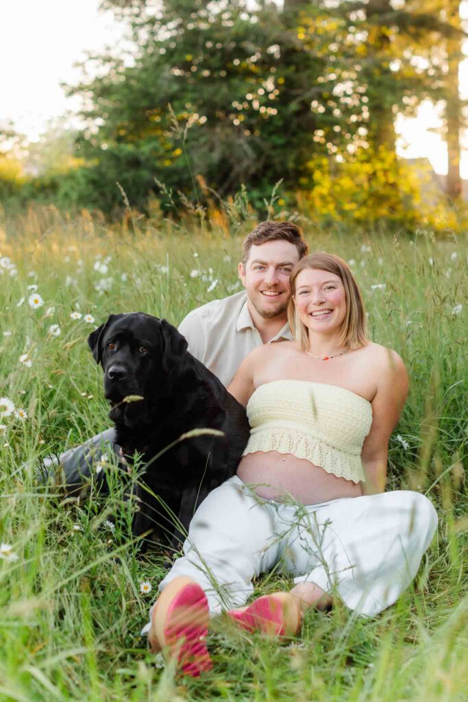 Sweet dog sitting beside an expecting couple during a dog-friendly maternity session in Camas, WA.