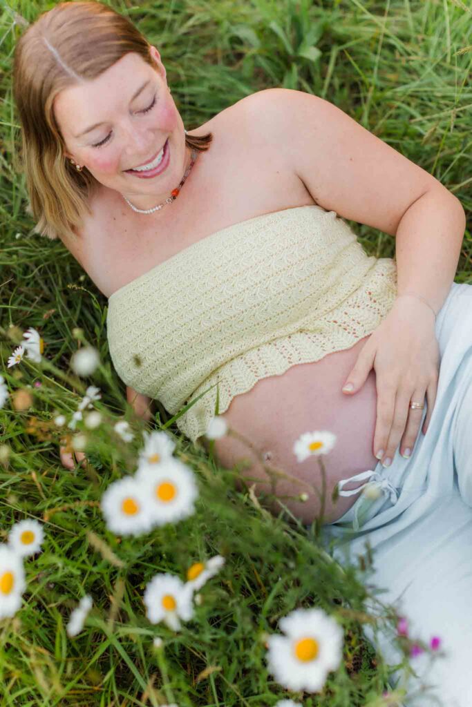 Camas WA maternity photographer capturing an expecting mom in a wild flower field.
