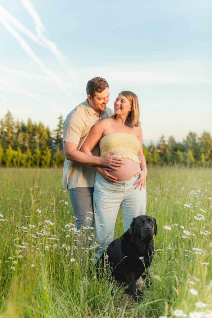 Expecting parents laughing together in a natural, candid maternity session in Camas, WA.