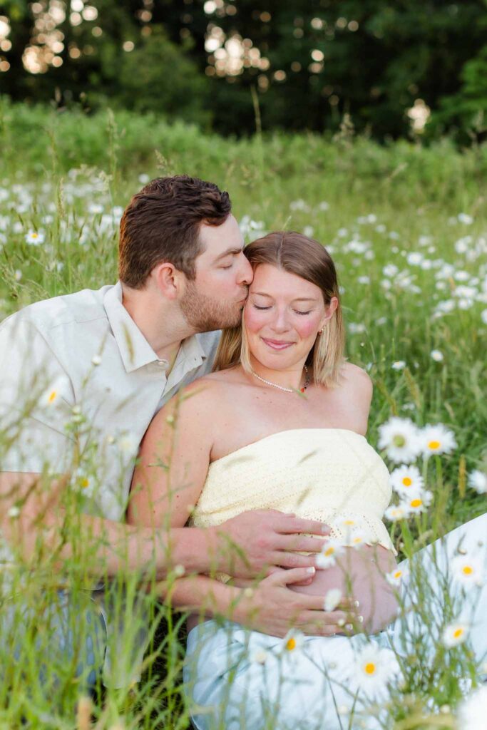 Romantic sunset maternity photo in a blooming wildflower field near Camas, Washington.
