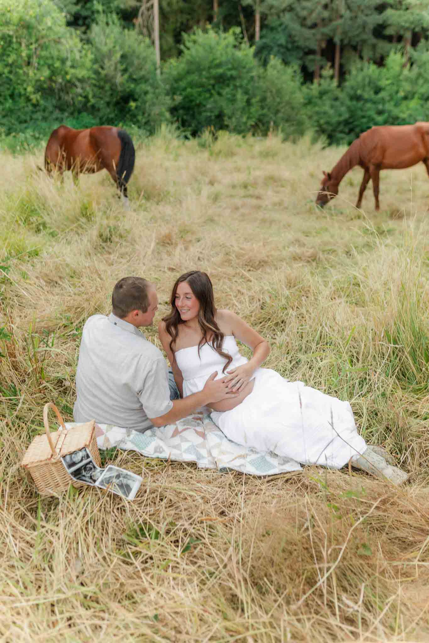 Western-inspired maternity session in a golden field with horses in Southwest Washington