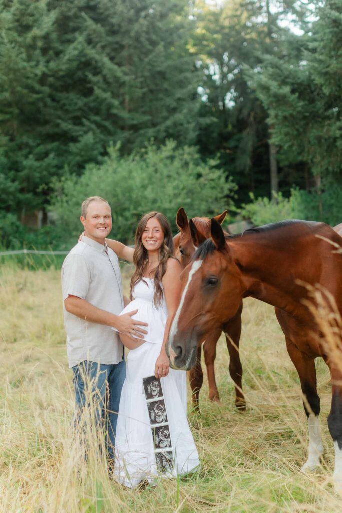 Parents-to-be holding ultrasound photos during a country maternity session